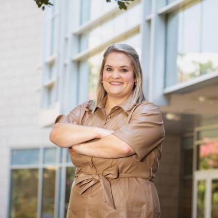 A business student in front of a building A business student in front of a building