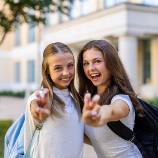 Two TCU students give the Frog hand sign. 