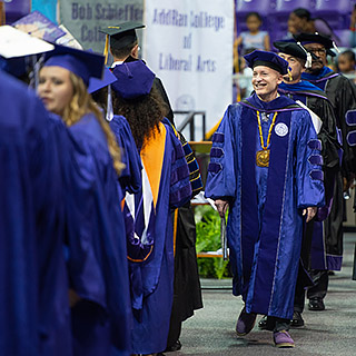 TCU Chancellor Commencement Walk Chancellor Victor J. Boschini, Jr., in full academic regalia, leading a commencement processional of faculty