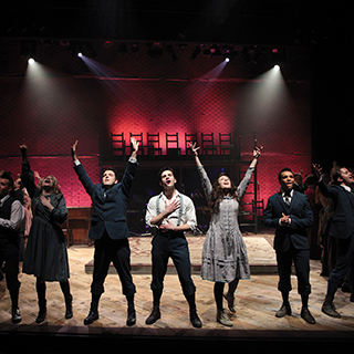 College of Fine Arts Student actors in a theatrical production of Spring Awakening sing together on stage