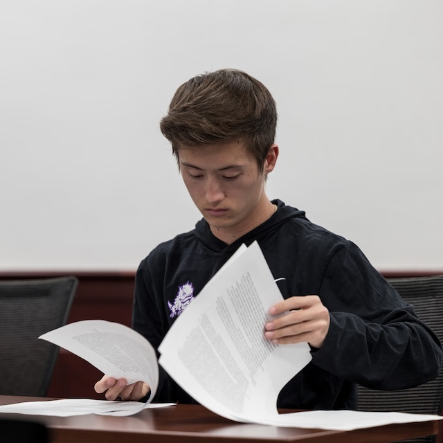 Student types on laptop outside