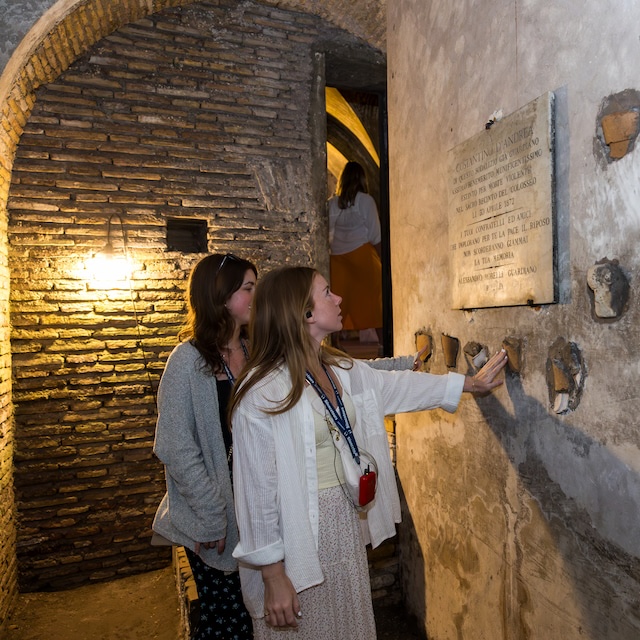 Two students look at a plaque underground
