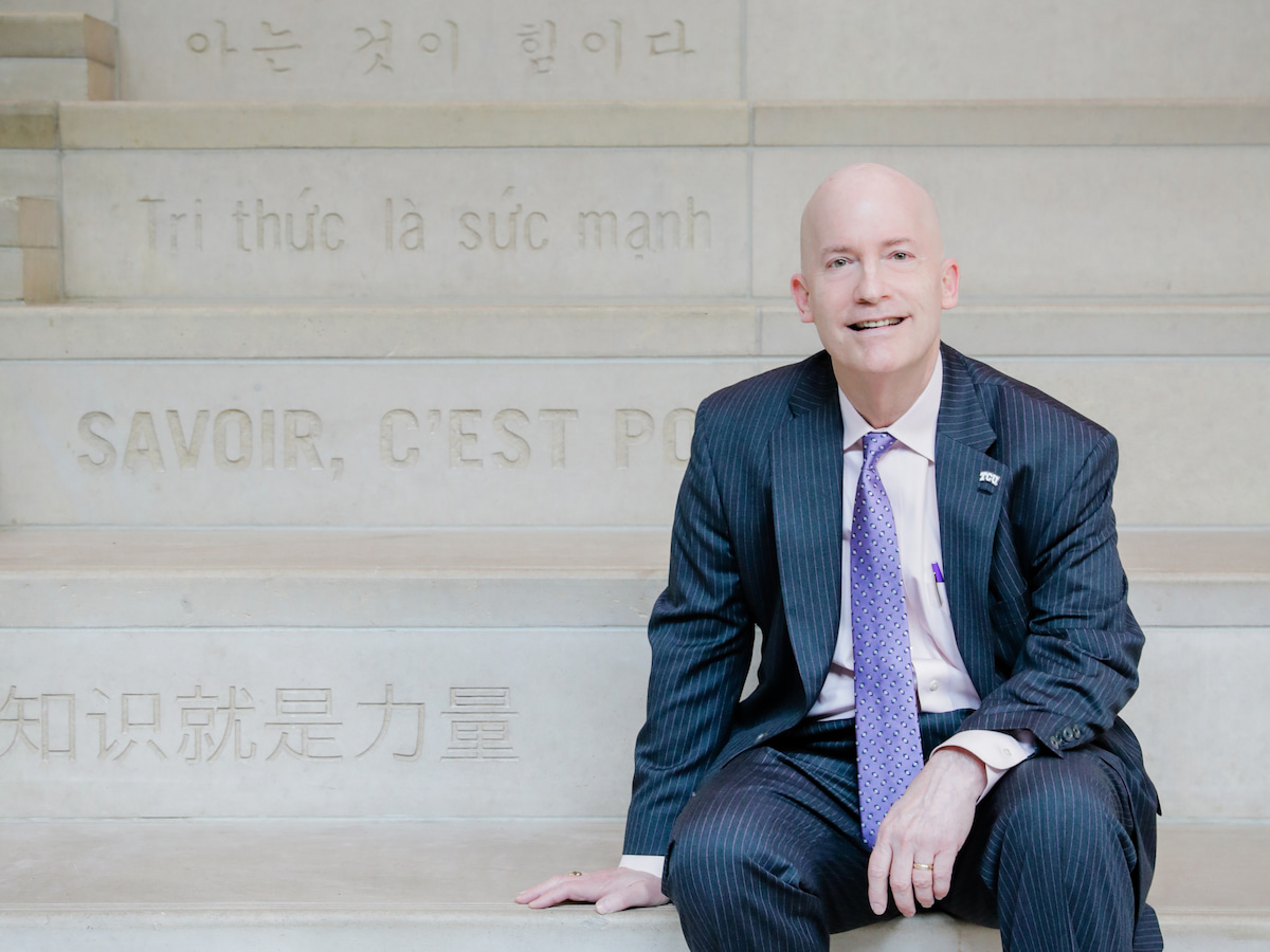 Victor J. Boschini, Jr. sitting on Knowledge is Power stairs