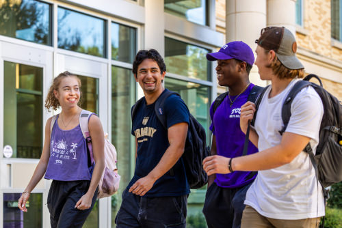 Four students walking together
