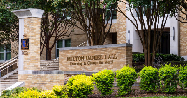 Outside steps to Milton Daniel Hall with a view of the Honors sign and building sign.