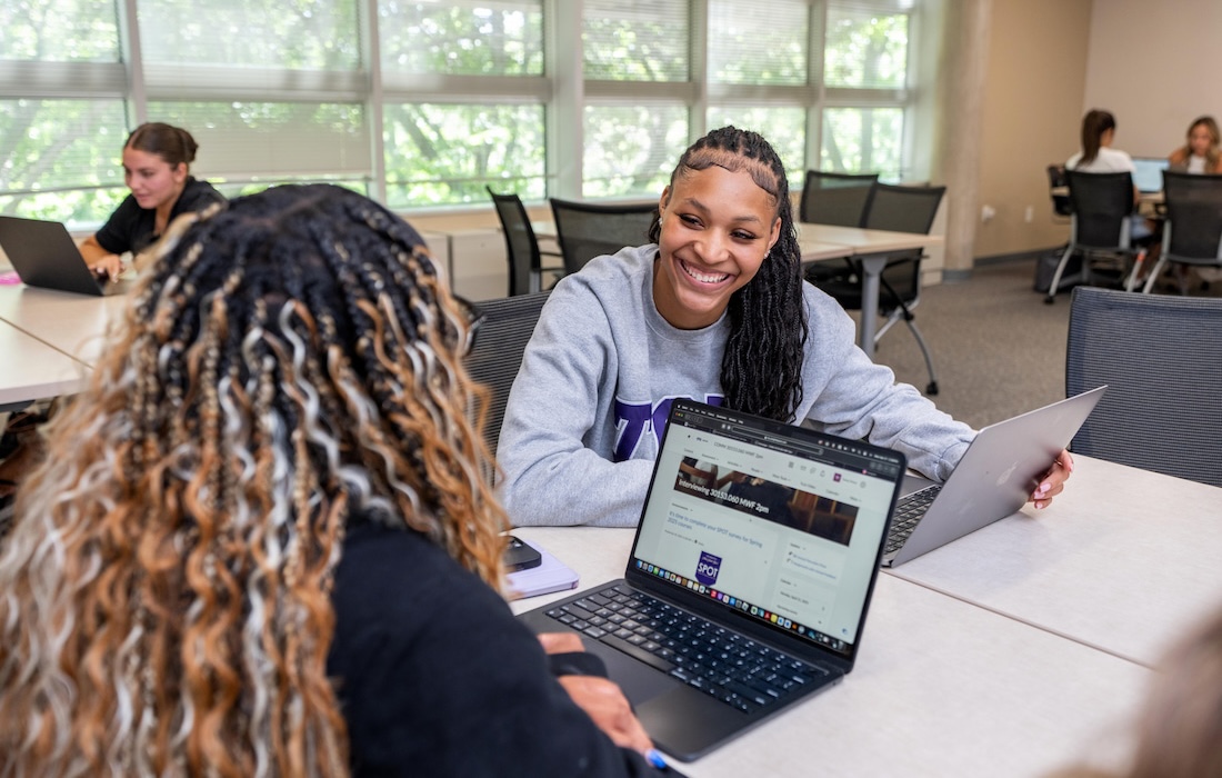 Two students communicating in a classroom
