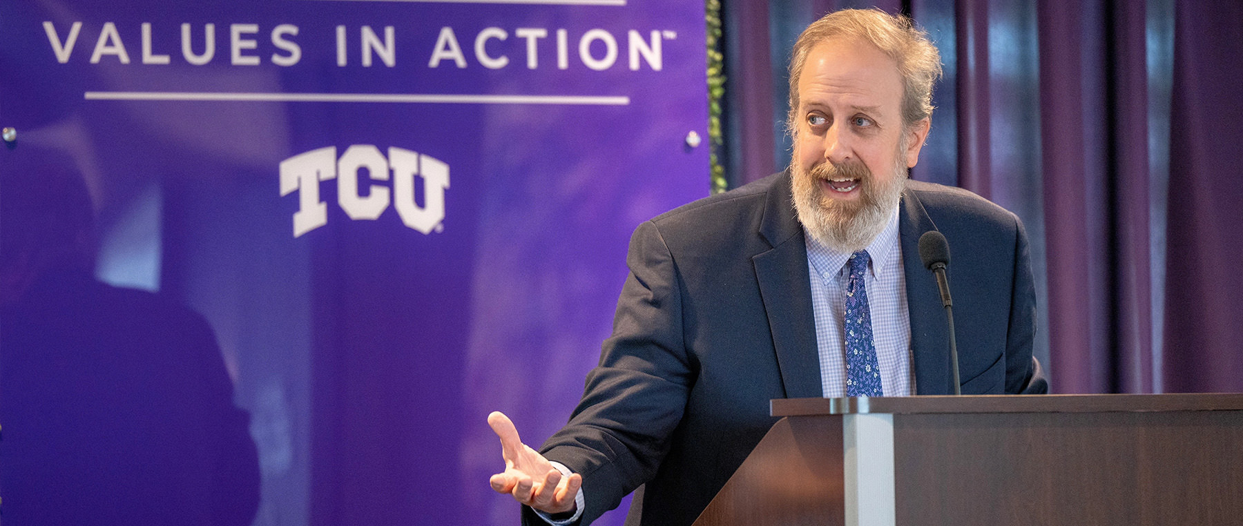 Tom Wavering speaking from a TCU lecturn